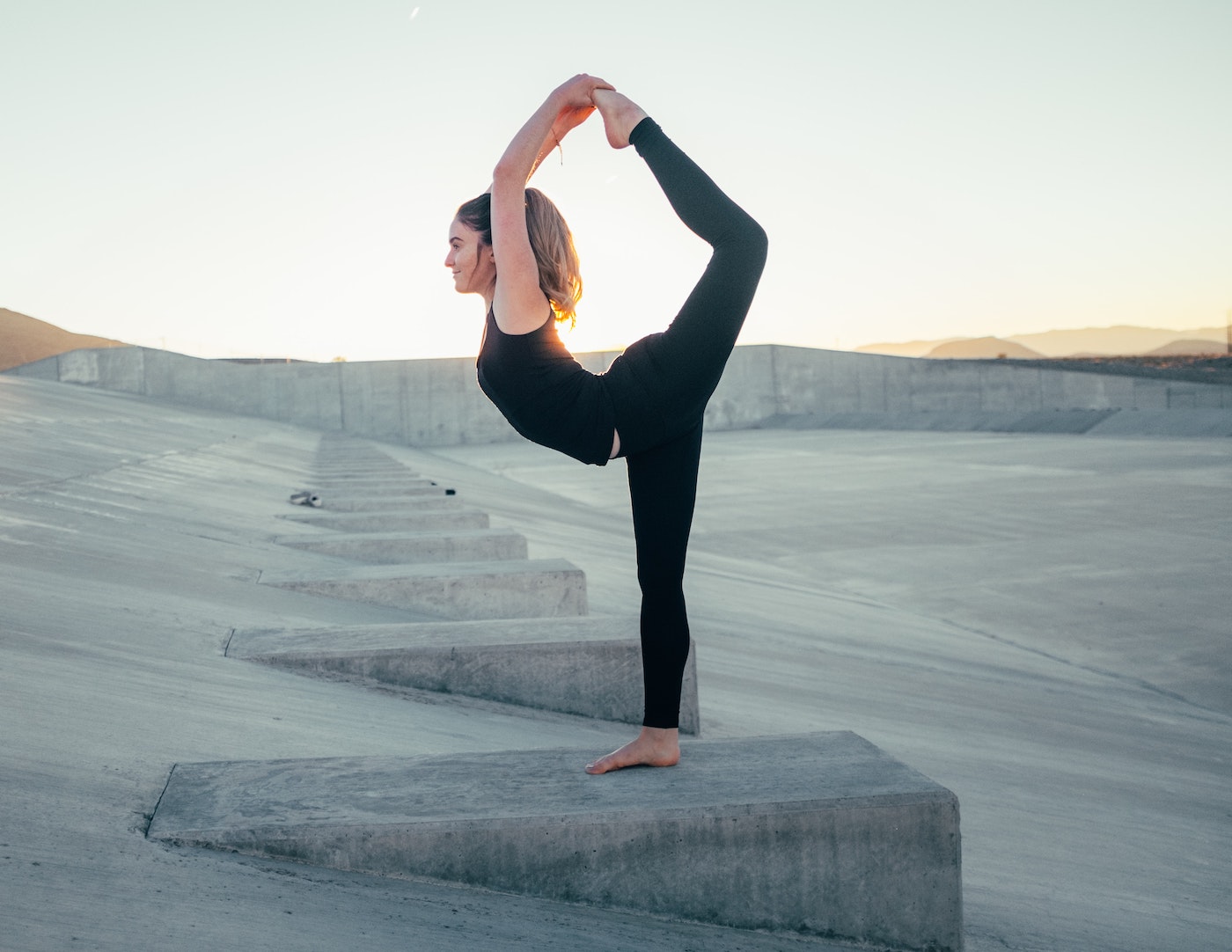 woman doing dancer pose yoga