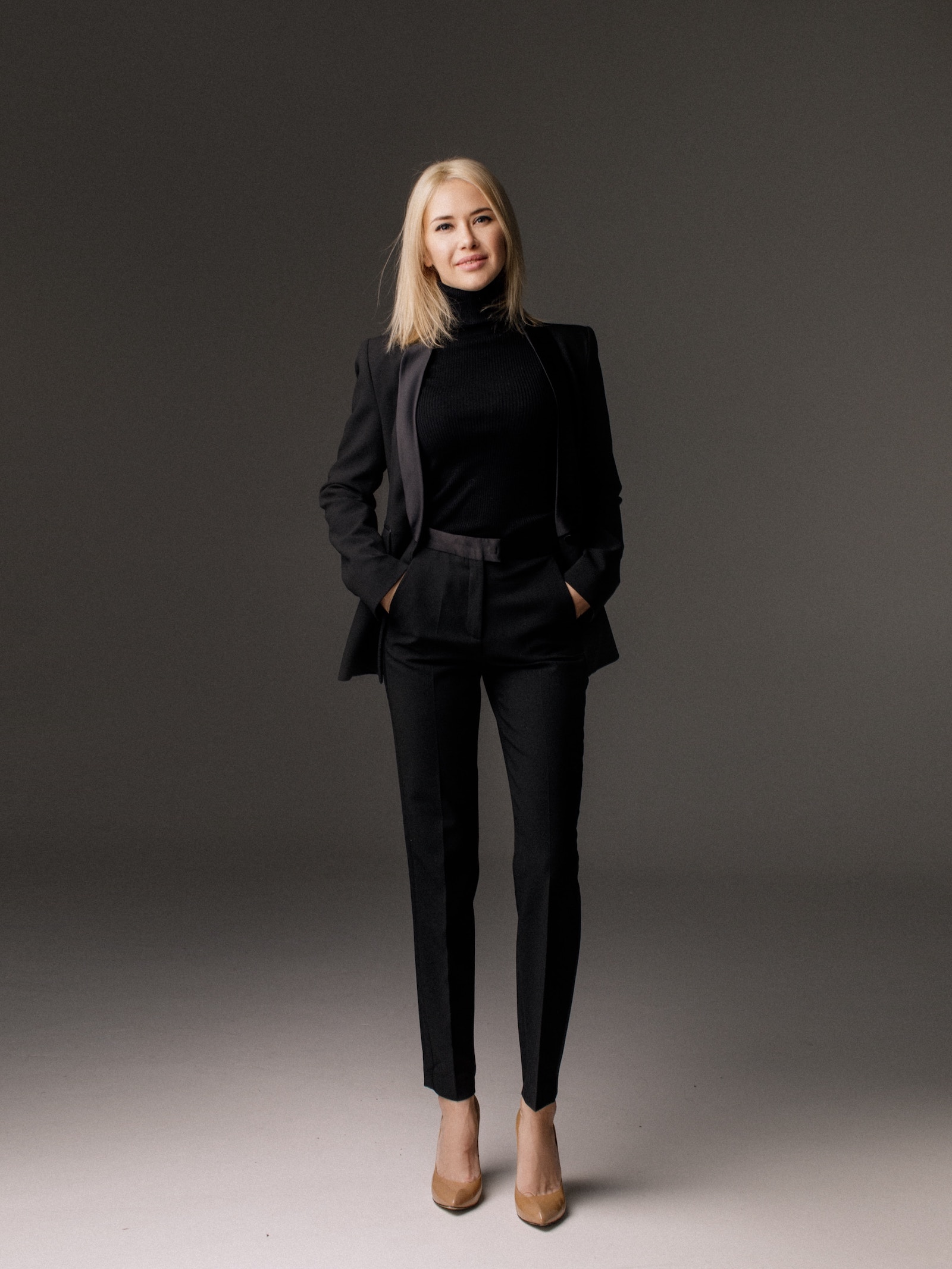 woman wearing all black pants suit pantsuit