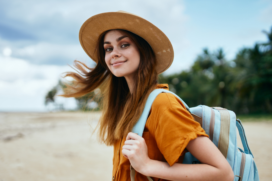 girl traveling to beach with backpack