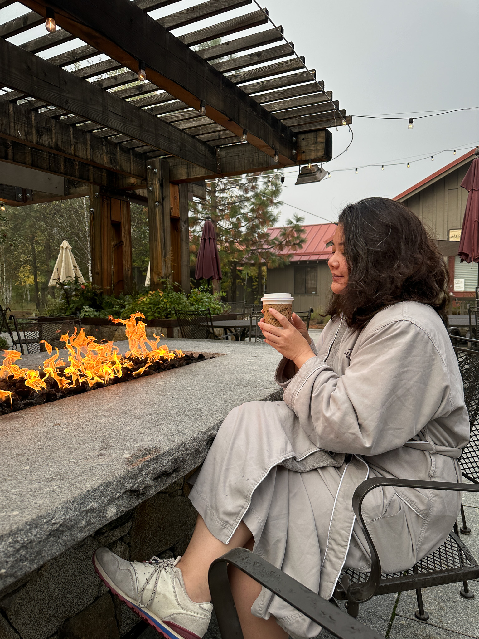 sleeping lady resort relaxing next to fire pit wearing a robe leavenworth
