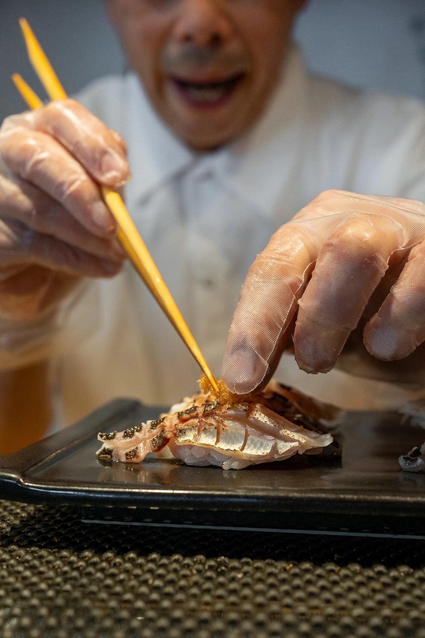 Chef Taro finishing kamasu japanese barracuda