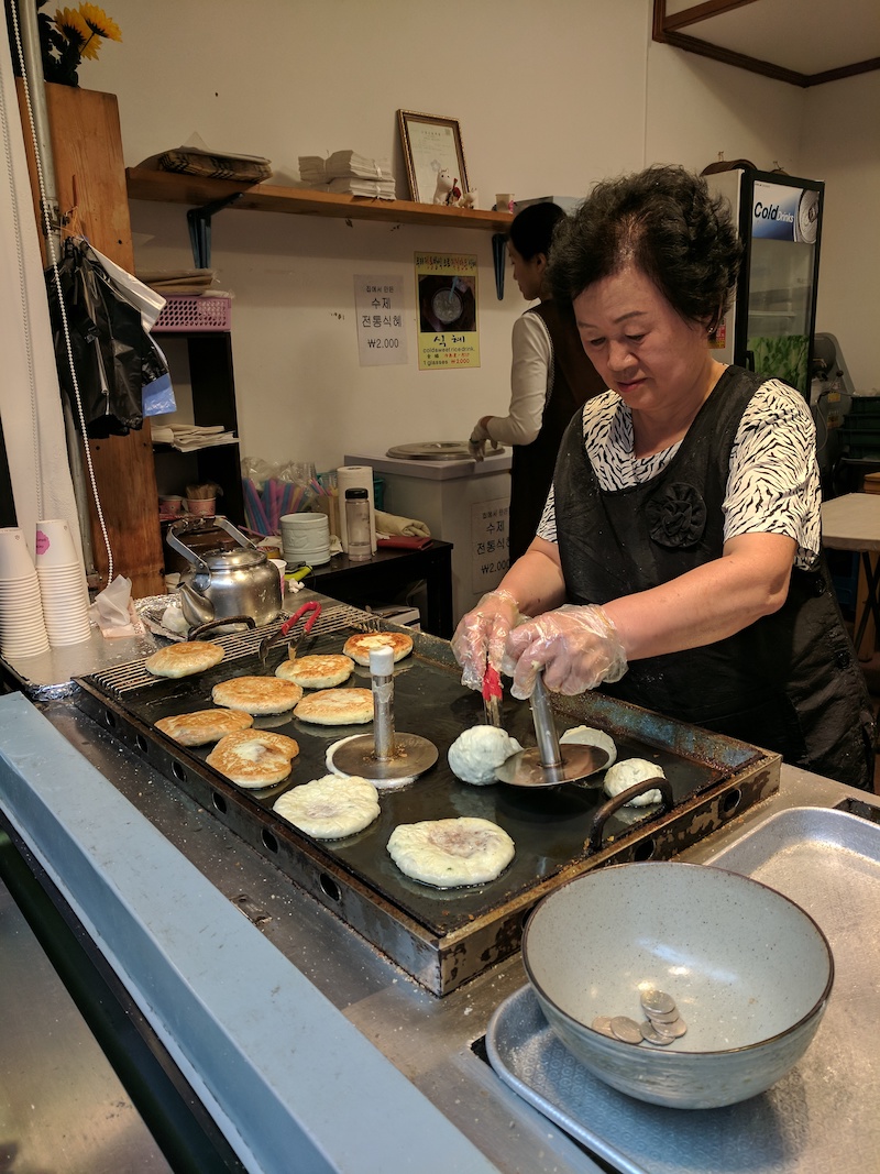 lady making Hotteok pancakes stand