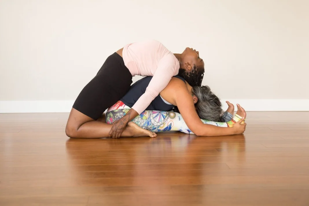 Supporting each other in Kapotasana and Forward Fold.