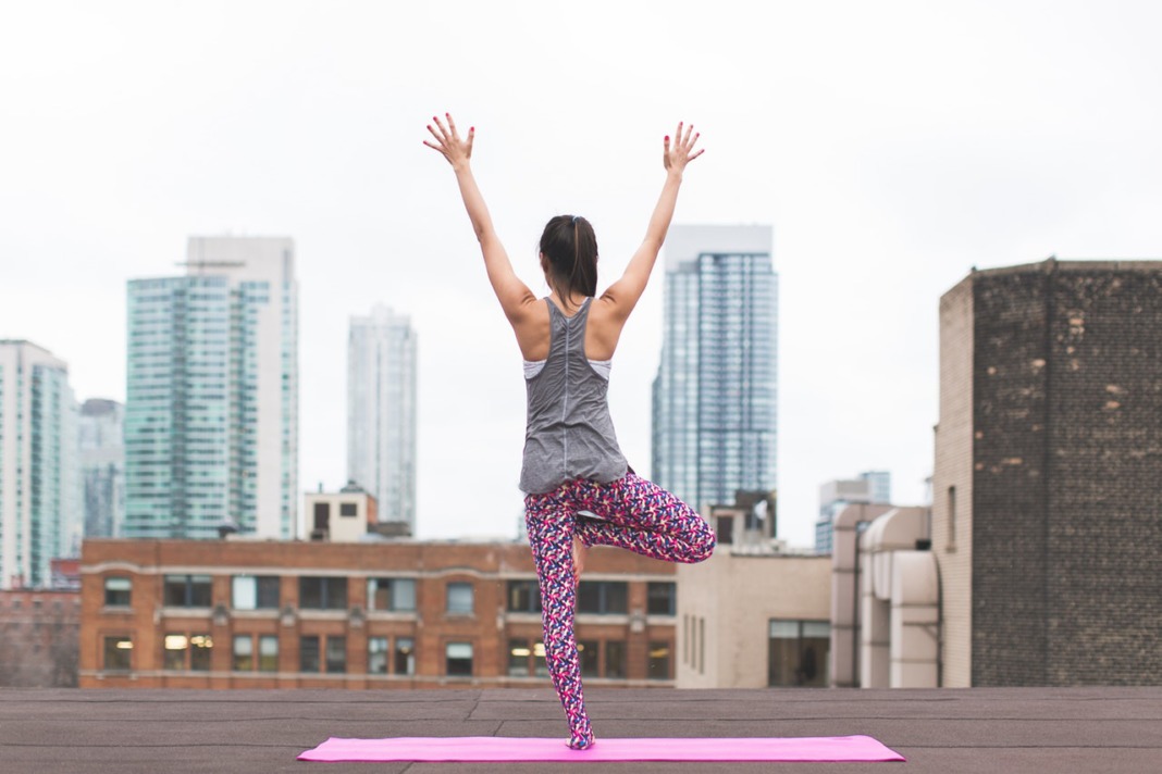 woman yoga rooftop tree pose vrksasana schimiggy reviews