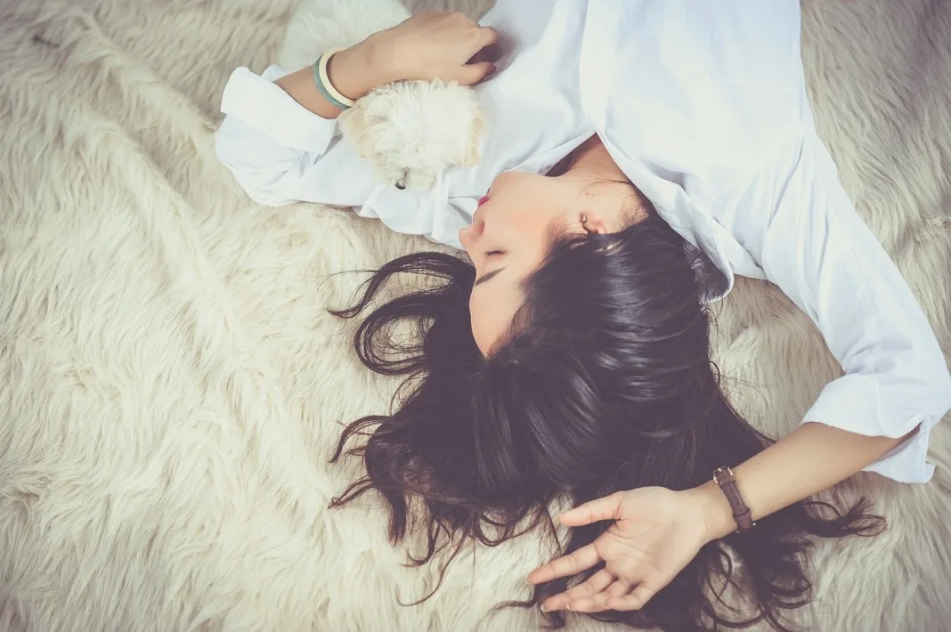 woman taking nap with dog