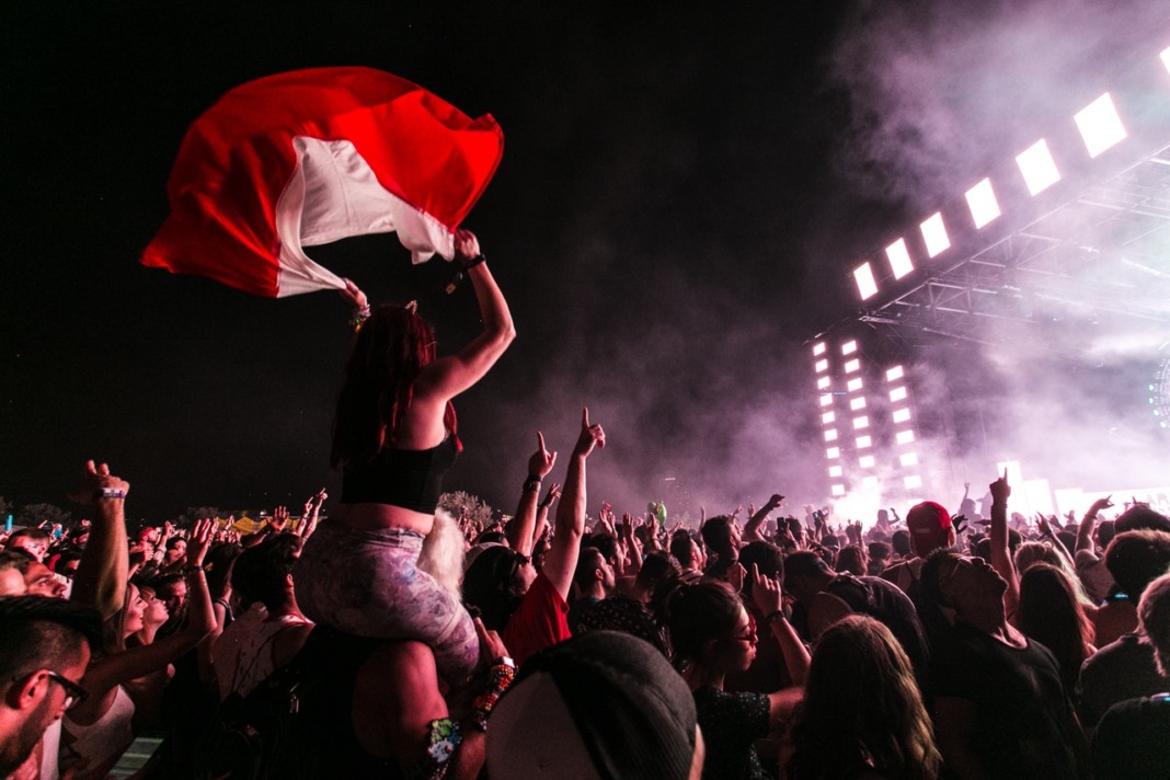 music festival stage woman sitting on shoulders