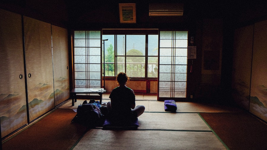 seated yoga pose looking outside window