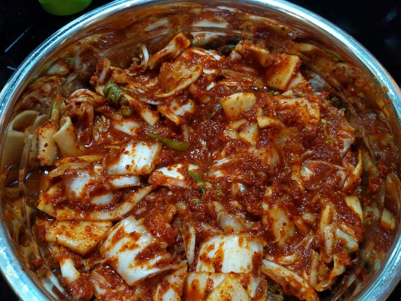 mixing kimchi recipe in a large bowl