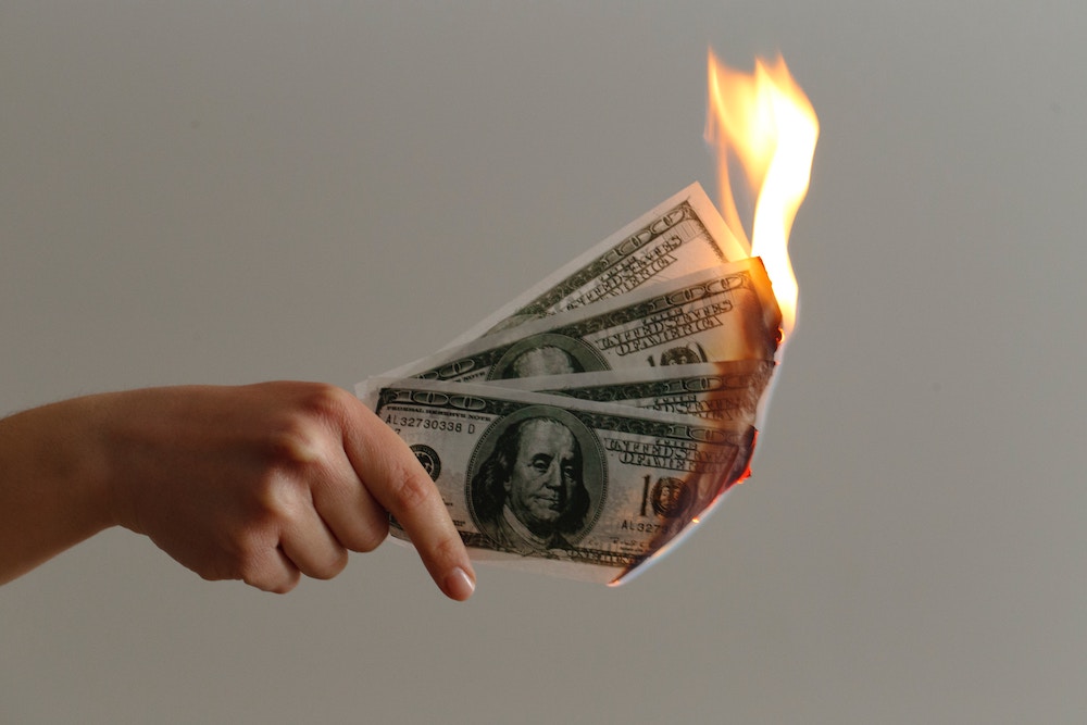 money burning losing cash over financial mistakes
