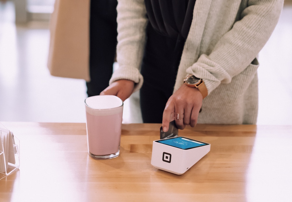 scanning credit card to make a purchase of food and beverage