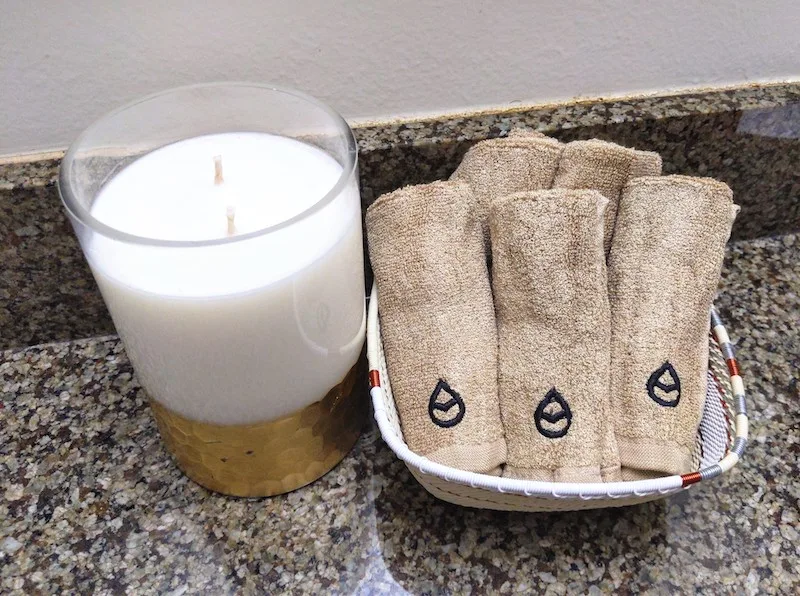 tushy towels in basket with candle