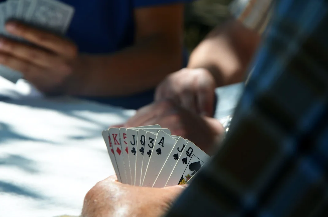 person playing card game at a table in casino