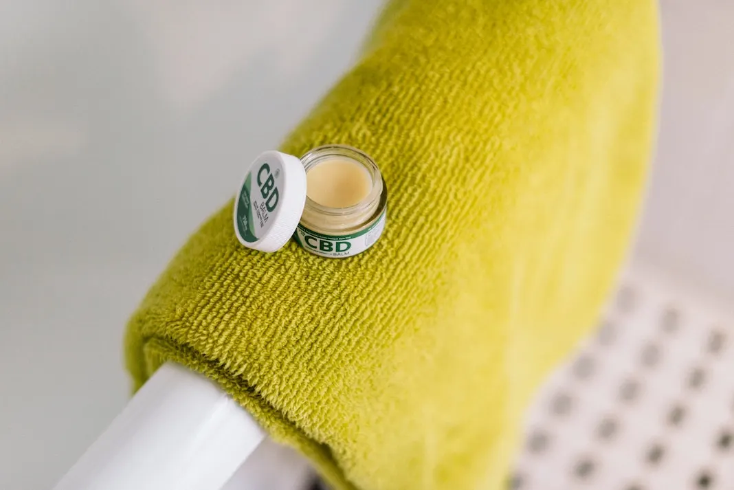 cbd balm in shower on towel