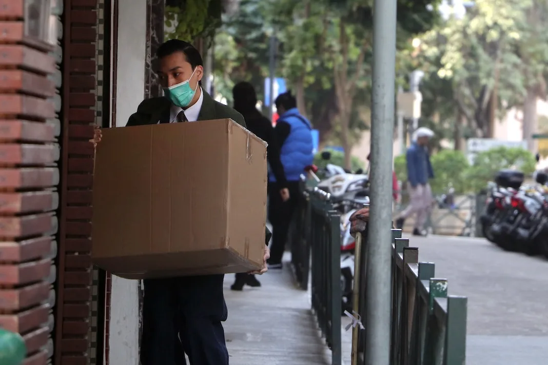 mailman delivering package to home