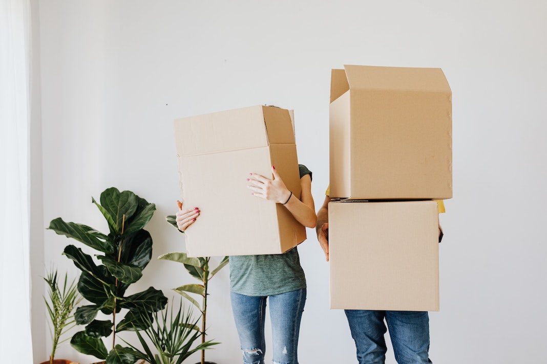 couple carrying moving boxes