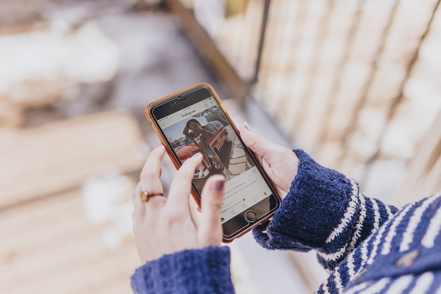 woman scrolling instagram feed on phone