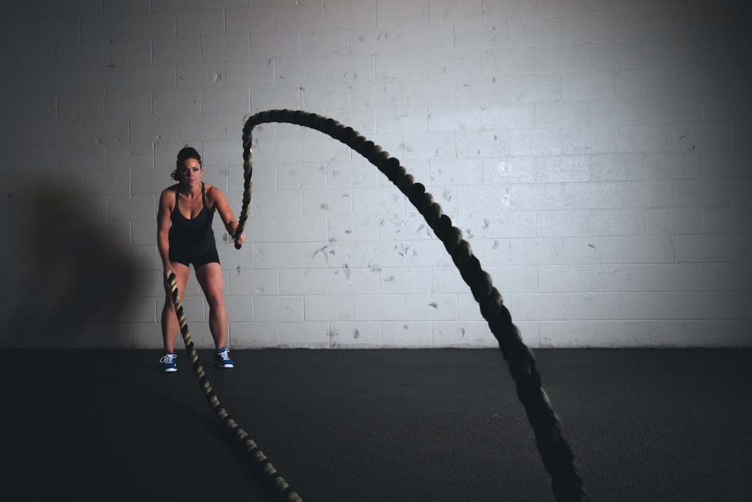 woman working out in gym with ropes