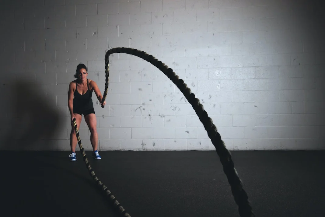 woman working out in gym with ropes