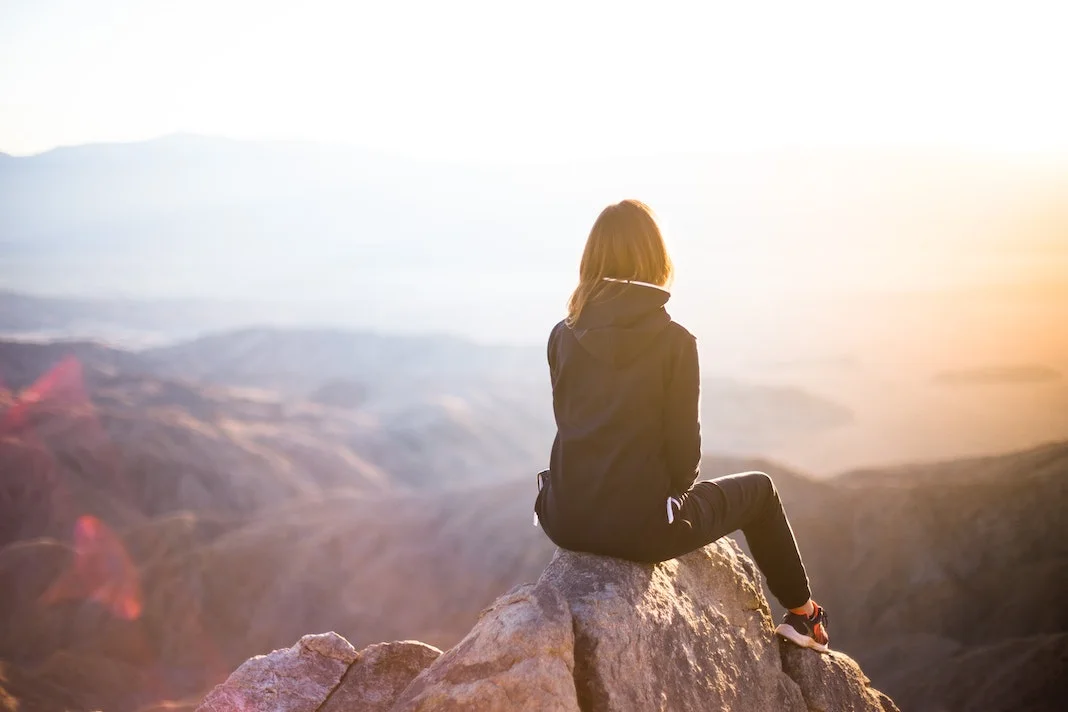 hiking and sitting at the top of a mountain