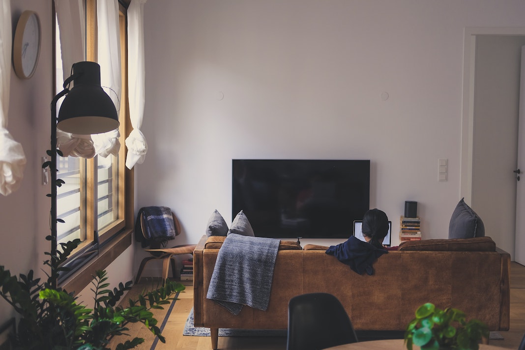 woman sitting in her cozy apartment