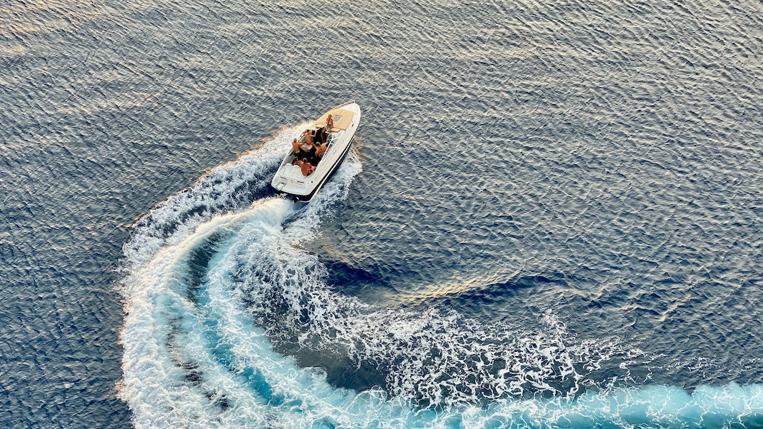 motor boat speeding on ocean water
