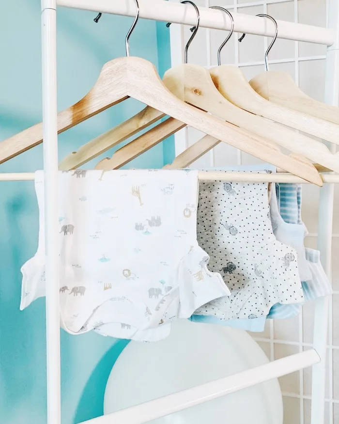 used baby clothes on rack drying