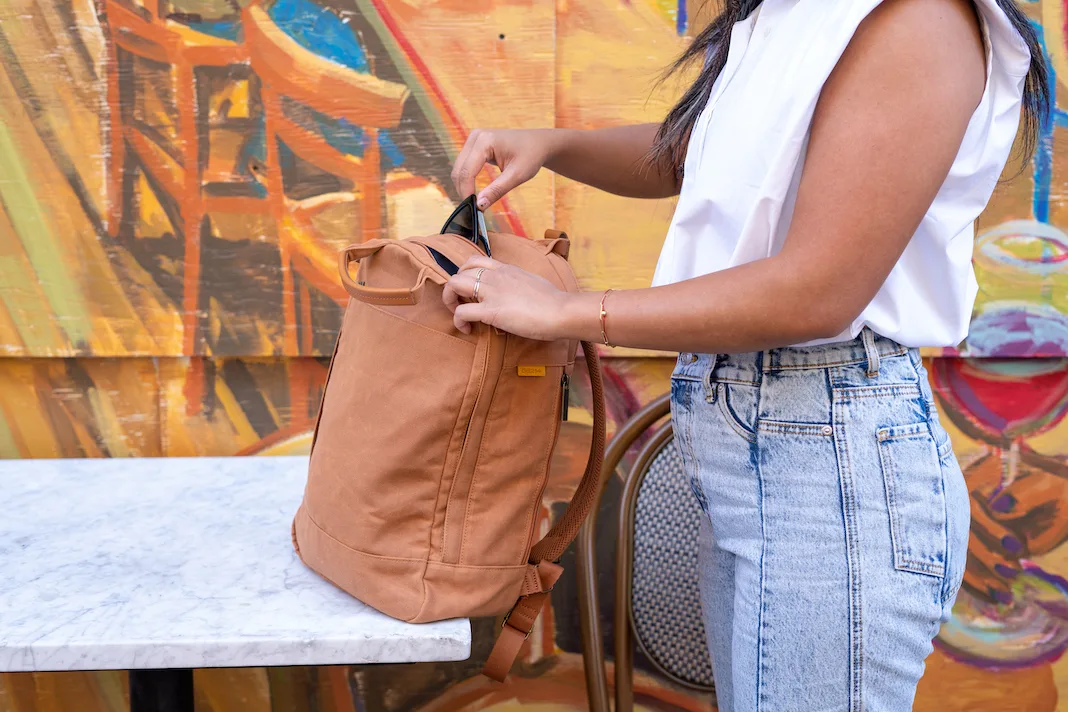 wearing ona sleeveless shirt with day owl maple backpack