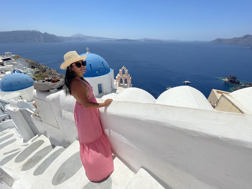 bright pink dress outfit in oia santorini