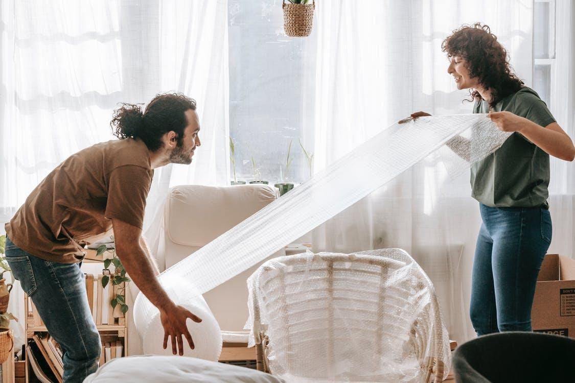 man and woman moving furniture