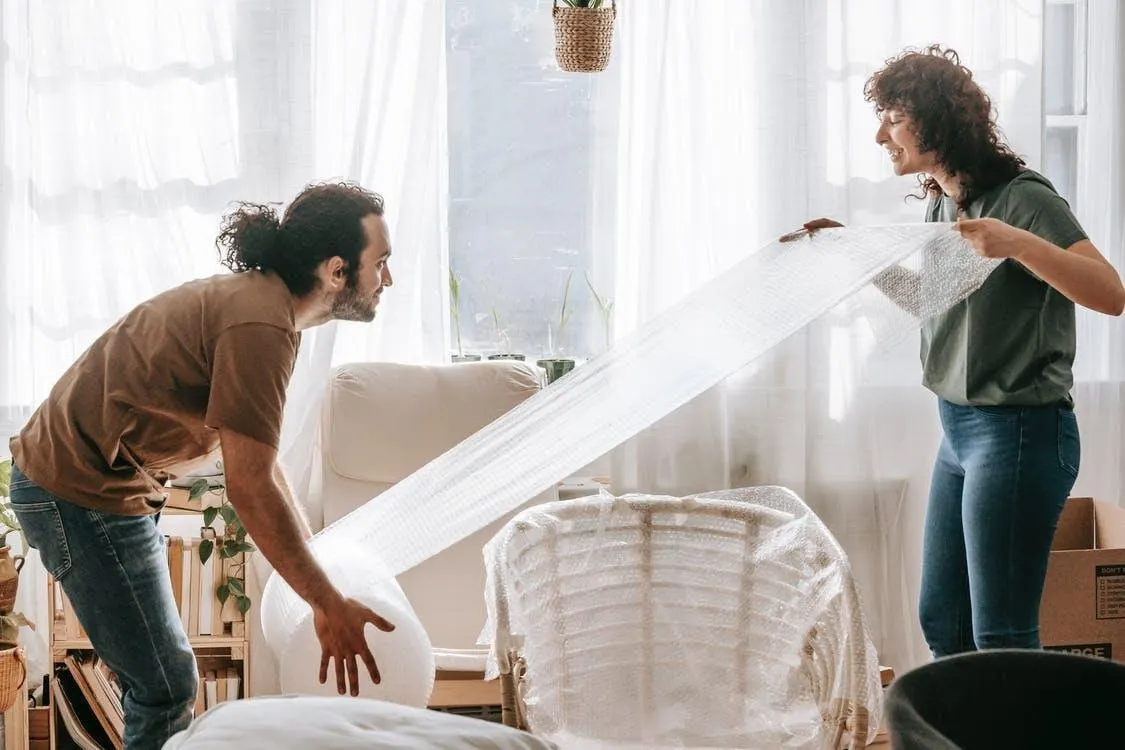 man and woman moving furniture
