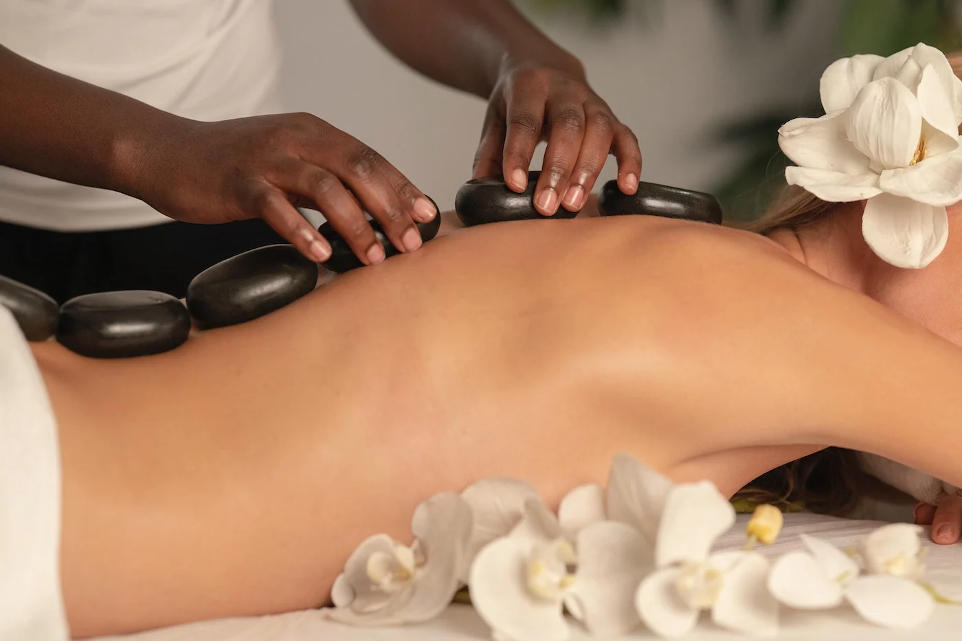 hot stones on womans back during massage
