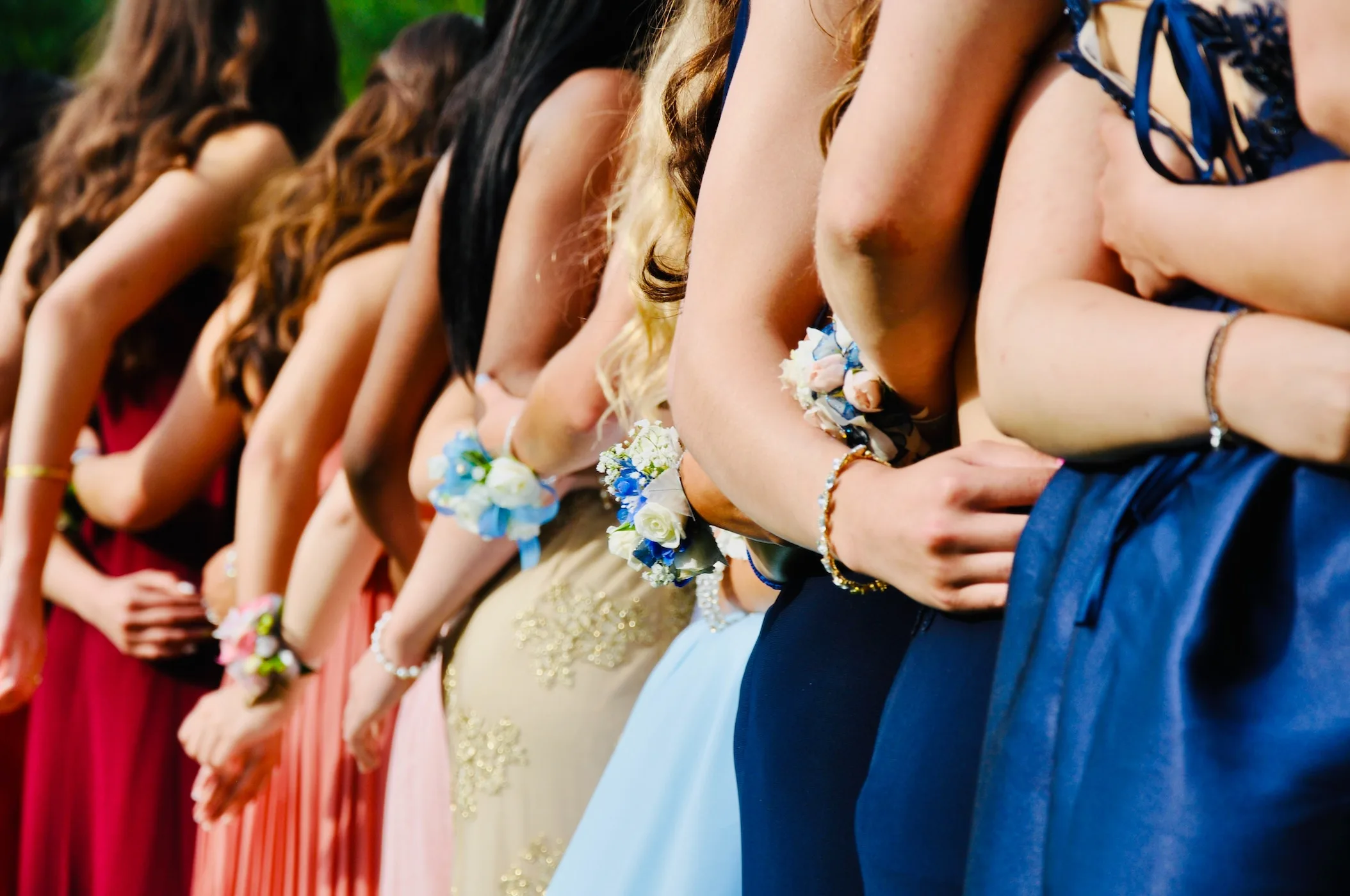 teenage girls wearing prom dresses
