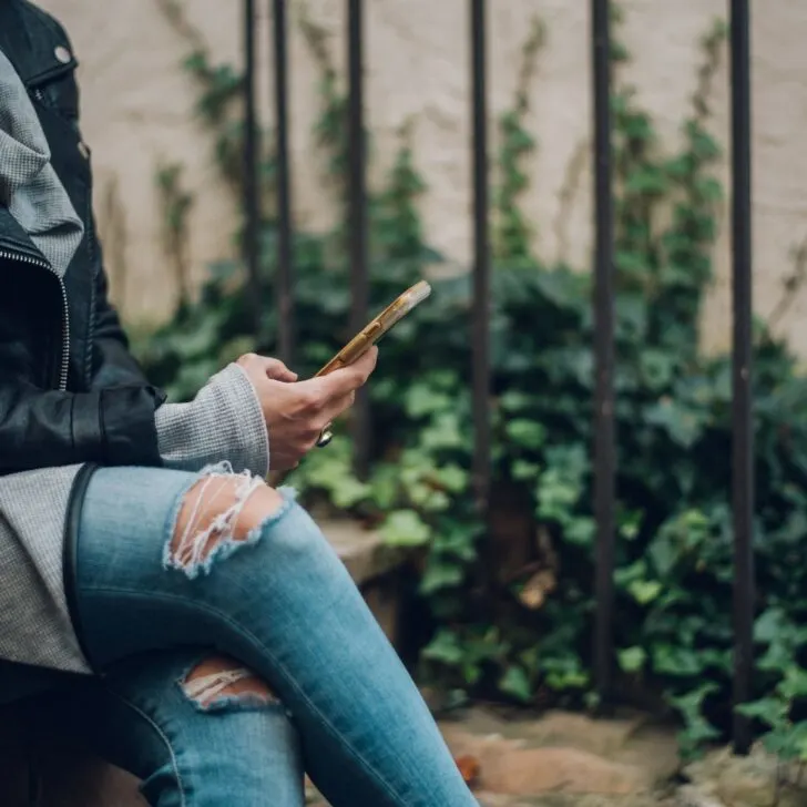 woman checking phone for messages calls and emails